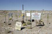 Atop Yucca Mountain, 90 miles northwest of Las Vegas, signs warn of possible radiation near a test well. 