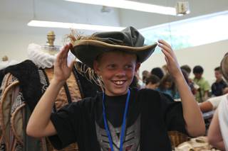 During a field trip of the Nevada Ballet Theater, fifth-grader Scott Ogan laughs while trying on a hat to be worn by the Nevada Ballet Company in their upcoming performance of 