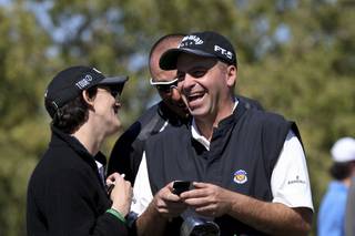 Rocco Mediate, right, laughs with physical therapist Cindi Hilfman, left, and Brandon Antus, caddy for Frank Lickliter II, after reading a text message on the putting green during the practice rounds of the Justin Timberlake Shriners Hospitals for Children Open at TPC Summerlin Tuesday.