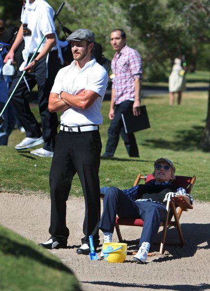 Justin Timberlake (left) provides shade for comedian and television host Ellen DeGeneres as she takes a break in a bunker during the Justin Timberlake Shriners Hospitals for Children Open pro-am at TPC Summerlin in Las Vegas, on October 15, 2008.
