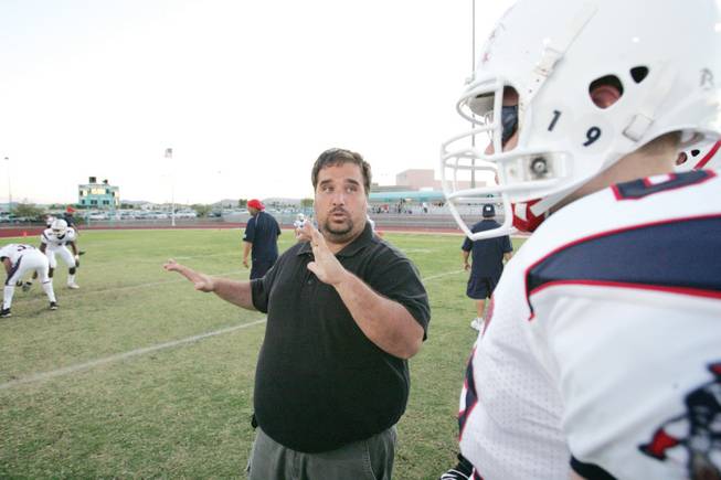 Liberty lineman Brandon Carey (63), who is deaf, listens to his interpreter before a game at Silverado on Sept. 19.