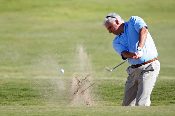 Actor John O'Hurley shoots out of a bunker during the ...