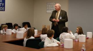 Clark County School District food service director Charles Anderson talks with 20 fifth-graders about nutrition before a tour of the CCSD central kitchen and lunch. 