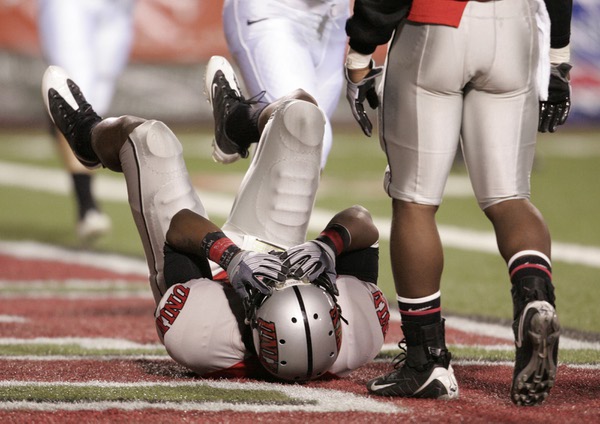 UNLV defensive back Geoffery Howard covers his face after getting ...
