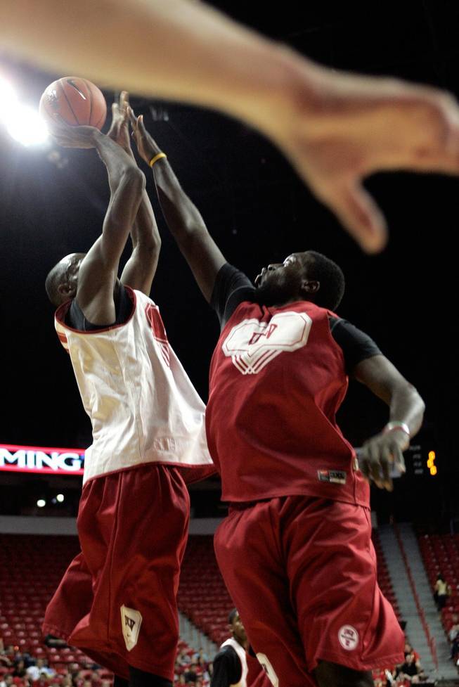 Beas Hamga, left, and Brice Massamba battle for a rebound during a scrimmage at the UNLV basketball team's first practice at the Thomas & Mack Center on Friday.
