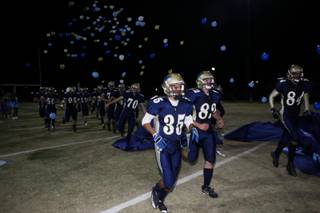 The Foothill football team enters the field on Friday night before its game against Basic. 