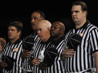 Football officials remove their caps during the national anthem Friday during pre-game ceremonies at Arbor View High School on Friday.
