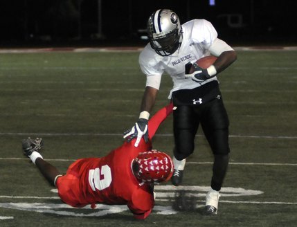 Panther running back Sidney Hodge (4) slips an open field tackle by Arbor View defender Xavion Johnson (2) during fourth-quarter action between the two teams at Arbor View High School Friday.