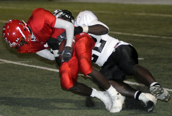 Aggies Demon Scurry (3) is brought down by Panther tackler ...
