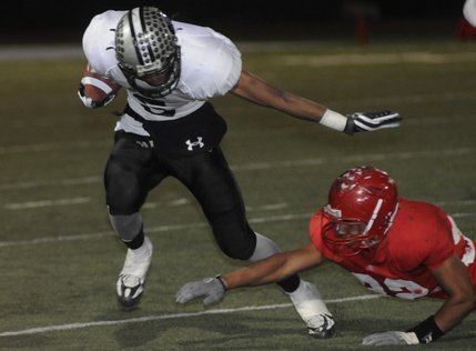 Palo Verde running back Torin Harris (5) slips by Aggies tackler Gabe Toney (32) on his way to a touchdown in the second half during Friday's game at Arbor View.