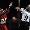 Panthers quarterback Kelly Zurowski (9) is pressured by Aggies defender Allen Jackson (20) during a 