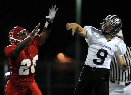 Panthers quarterback Kelly Zurowski (9) is pressured by Aggies defender Allen Jackson (20) during a game at Arbor View High School Friday.