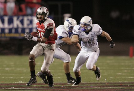 UNLV wide receiver Phillip Payne eludes Air Force defensive end Rick Ricketts, center, and Luke Yeager during the second half of Saturday's game at Sam Boyd Stadium.