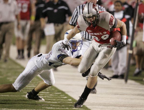 UNLV wide receiver Ryan Wolfe tries to stay in bounds ...