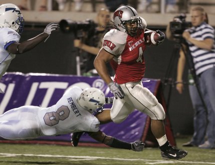 UNLV running back Frank Summers runs past Air Force cornerback Reggie Rembert and into the end zone during the second half of Saturday's game.