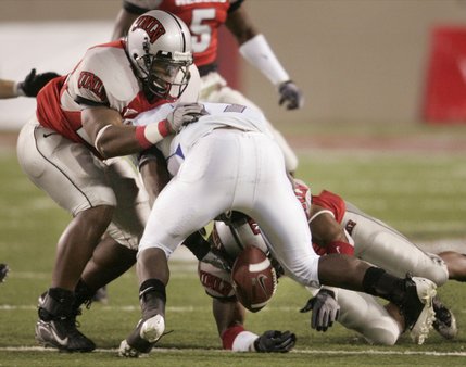 UNLV defensive backs Wiselet Rouzard, left, and Lorenzo Bursey force Air Force's Asher Clark to fumble during the second half of Saturday's game at Sam Boyd Stadium. Clark recovered the fumble and Air Force went on to win, 29-28.