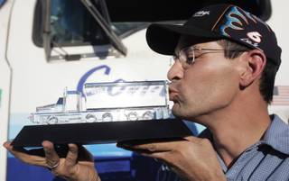 Brandon Hardy kisses the trophy he received when he was named the best professional truck driver in Nevada after winning the flatbed competition and receiving the highest overall score in the seven categories at the 2008 Nevada Truck Driving Championships.