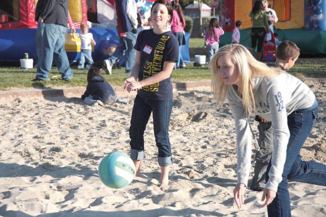 Lauren Bickens, left, and Julie Dramise, both 14, play volleyball with friends during Green Valley Baptist Church and New Community Church's annual steak fry and picnic at Silver Springs Park.
