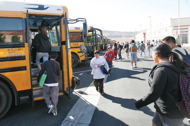 Faiss Middle School students board school buses after class on Thursday.