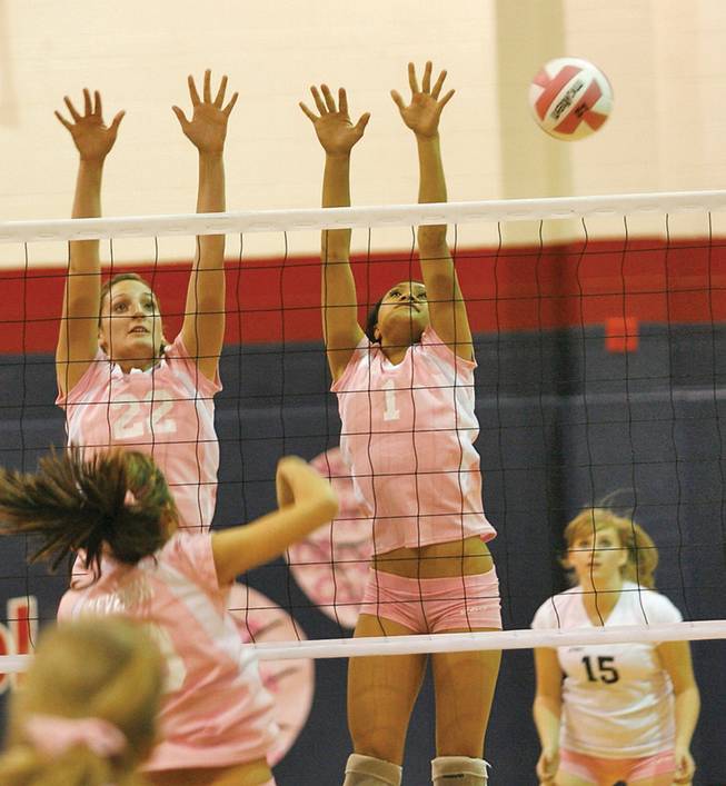 Coronado's Kristen Herlosky (22) and Kuulei Piena (1) attempt to block a shot from Foothill during the 'Dig Pink' breast cancer rally at Coronado High on Oct. 16.
