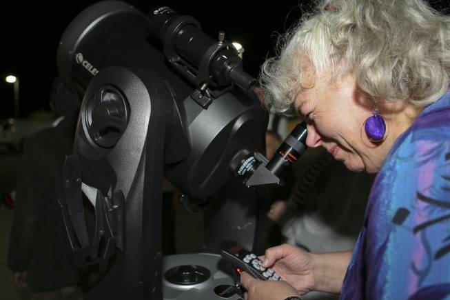 Utilizing the GPS keypad, senior Linda Kile navigates the Celestron 8-inch reflector telescope to a precise location, looking for bright stars during astronomy class at Nevada State College.