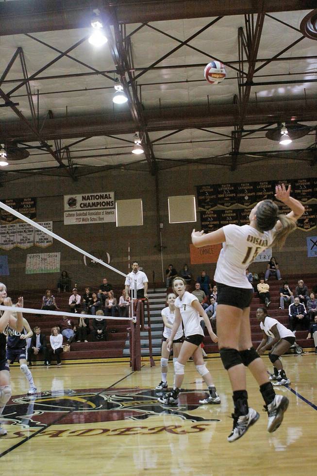 Hayley Washinsky, a junior on the Faith Lutheran girls volleyball team, leaps to spike the ball against Lake Mead Christian Academy.