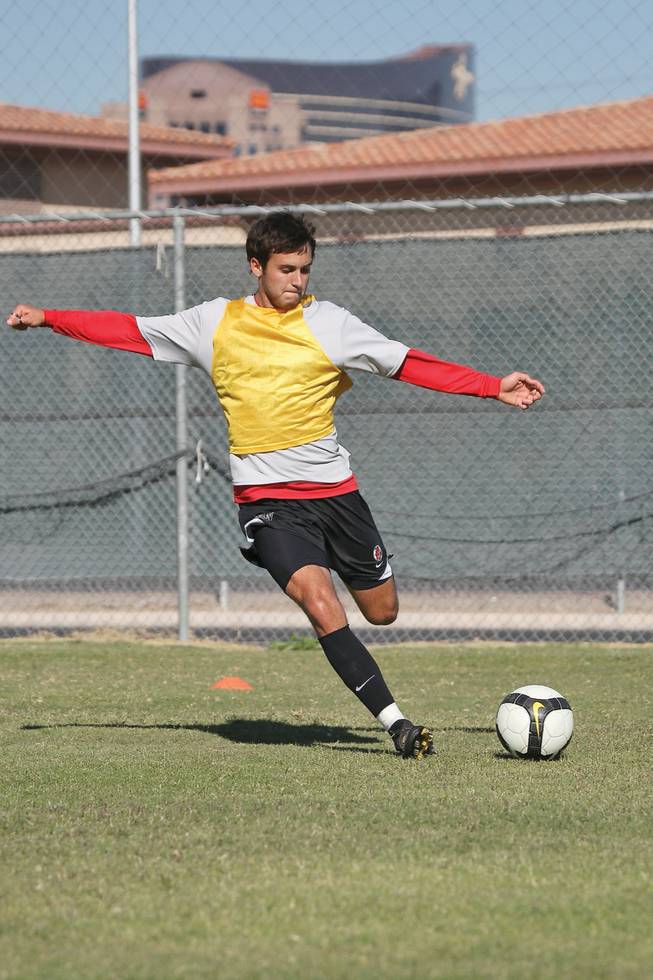 While running possession drills, outside midfielder Zac Zaher shoots the ball during a team practice at UNLV.