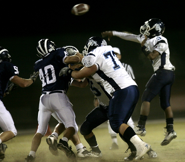 Centennial quarterback Chris Henderson jumps over the Shadow Ridge line ...