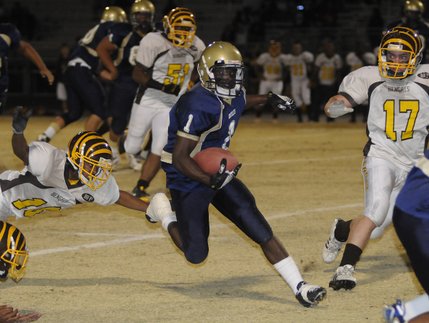 Grizzlies running back Jacques Adams (1) bursts through a hole in the Bonanza line for a big gain in the first quarter of Friday's game at Spring Valley.