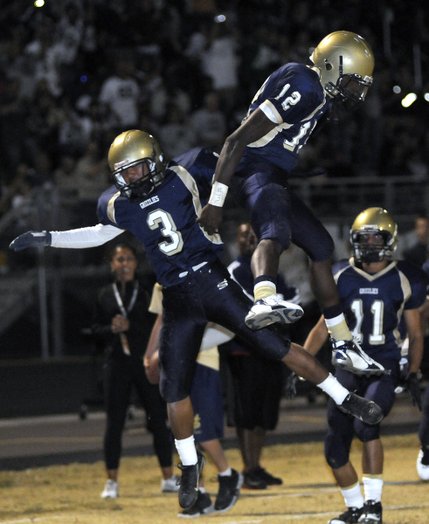 Spring Valley wide receiver Jeff Fajardo (3) celebrates with quarterback Anton Stallworth (12) after the two connected for a touchdown against Bonanza. Spring Valley defeated Bonanza, 37-7.