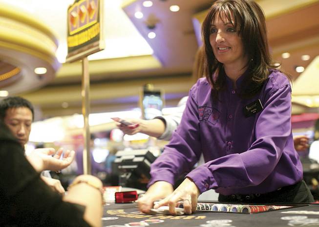 Bosiljka Jevremovic deals three-card poker Thursday at the Stratosphere. Some dealers complain about wages and strict new management; others say they are more appreciated and slackers aren't getting away with not pulling their weight.
