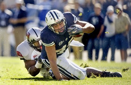 BYU running back Harvey Unga (45) struggles for more yardage against UNLV defensive back Wiselet Rouzard (22) on Oct. 25. The Cougars are none too pleased about appearing in a fourth-straight Las Vegas Bowl.
