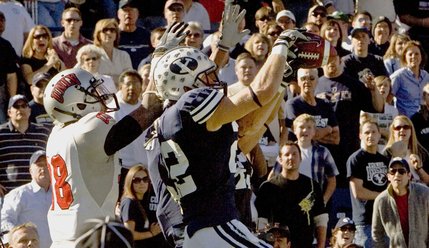 BYU defensive back Andrew Rich (22) intercepts a ball intended for UNLV wide receiver Ryan Wolfe (88) in the end zone during the fourth quarter on Saturday. 