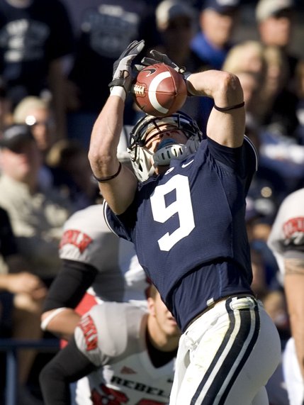 BYU wide receiver Austin Collie (9) completes a pass against UNLV during the third quarter. Collie finished the day with 113 receiving yards. BYU defeated UNLV 42-35. 