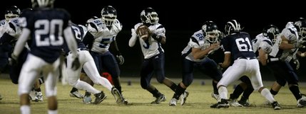 Centennial quarterback Chris Henderson drops back for a pass during Friday night's game.