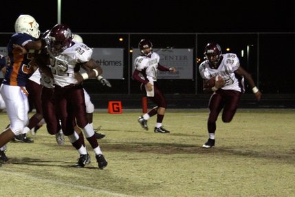 Cimarron-Memorial running back Stephen Nixon (25) runs while James Poole (22) blocks Legacy's defense.