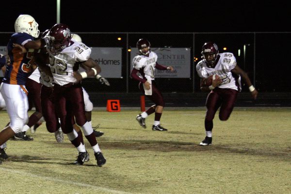 Cimarron-Memorial running back Stephen Nixon (25) runs while James Poole ...