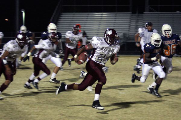 Cimarron-Memorial junior Stephen Nixon runs the ball during Friday's game ...