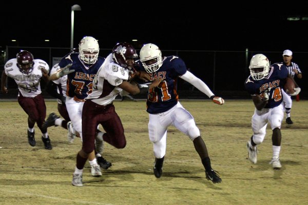Legacy's Prince Oroke (31) blocks Cimarron-Memorial's Triton Manumaleuna (84) while ...