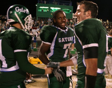 Jason Ware (54) congratulates teammate Dallas Halasz (5) on his second touchdown of the night in the fourth quarter. Green Valley beat Silverado 31-13.