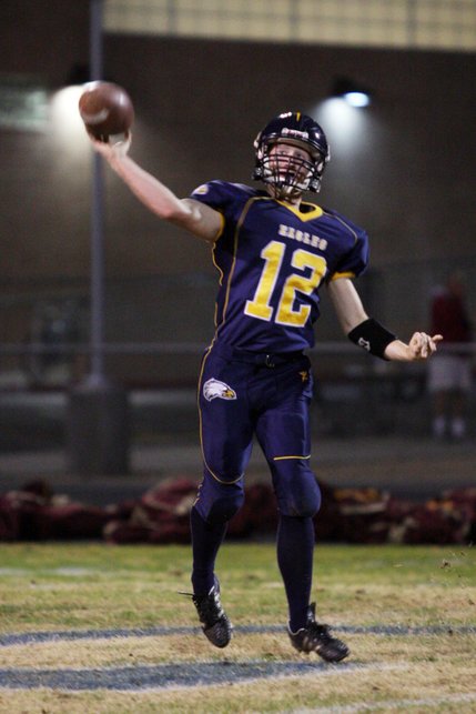 Boulder City quarterback Jake Phillips throws a pass to a teammate during a home football game against Faith Lutheran on Friday.