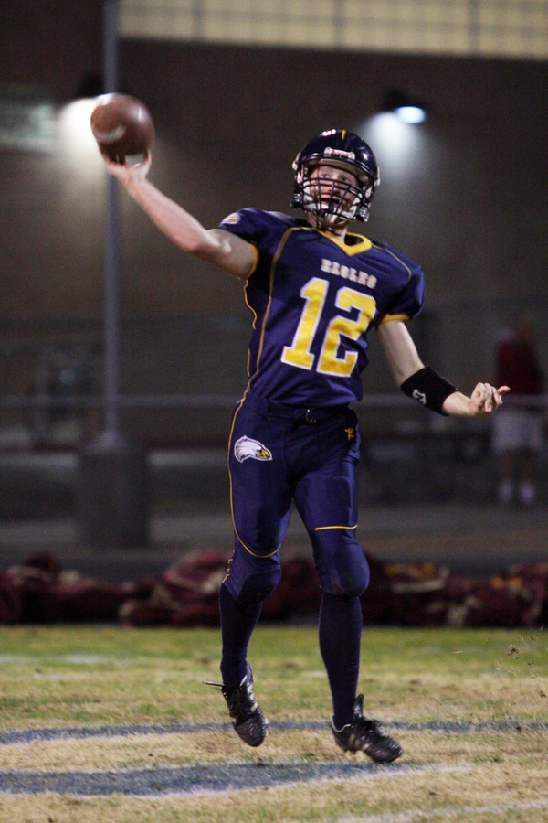 Boulder City quarterback Jake Phillips throws a pass to a ...
