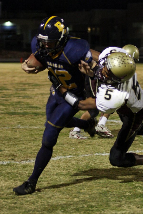 Boulder City quarterback Jake Phillips attempts to avoid Faith Lutheran's ...