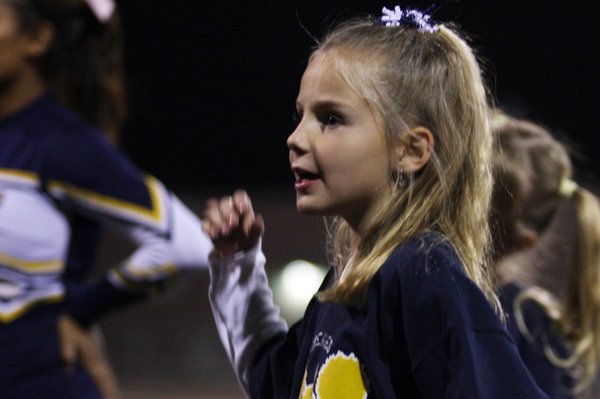 Ryanne Reese, 8, a junior Eagle cheerleader, performs during halftime ...