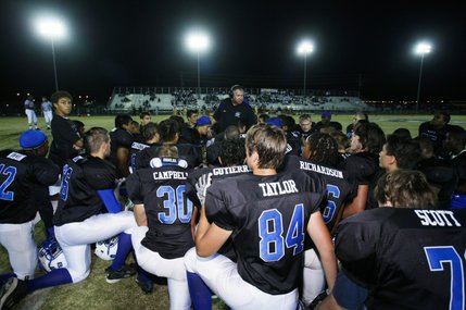 Basic coach Jeff Cahill gives the team a pep talk during the game Friday.