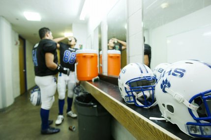 Basic players take a break in the locker room during halftime. 