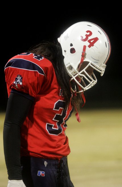 With his head down, Liberty's Ryan Doty walks off the field after a disappointing loss Friday night to Foothill.
