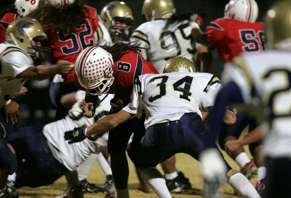 Liberty's Ian Jackson (8) tries to fight through before being ...