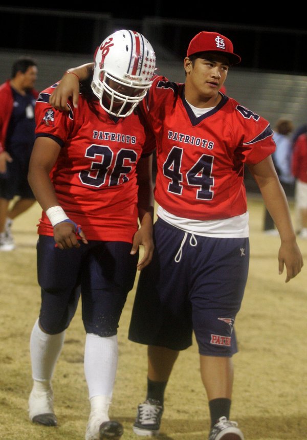 Liberty's Samson Toalei (44) puts his arm around Jordan Kapeli ...