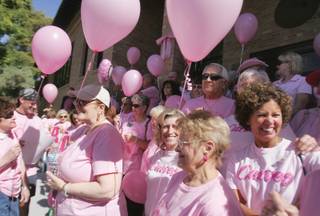 Boulder City residents line up for a picture in front of City Hall on Friday in honor of Passionately Pink breast cancer day.